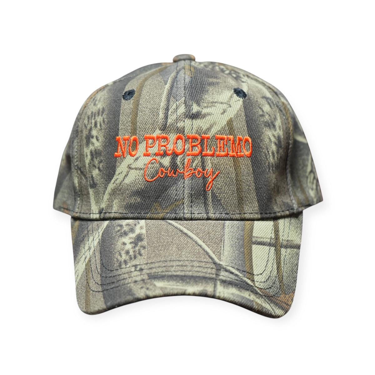 Camo polyester dad hat with a curved brim and “NO PROBLEMO COWBOY” embroidered across the front in burnt orange thread.