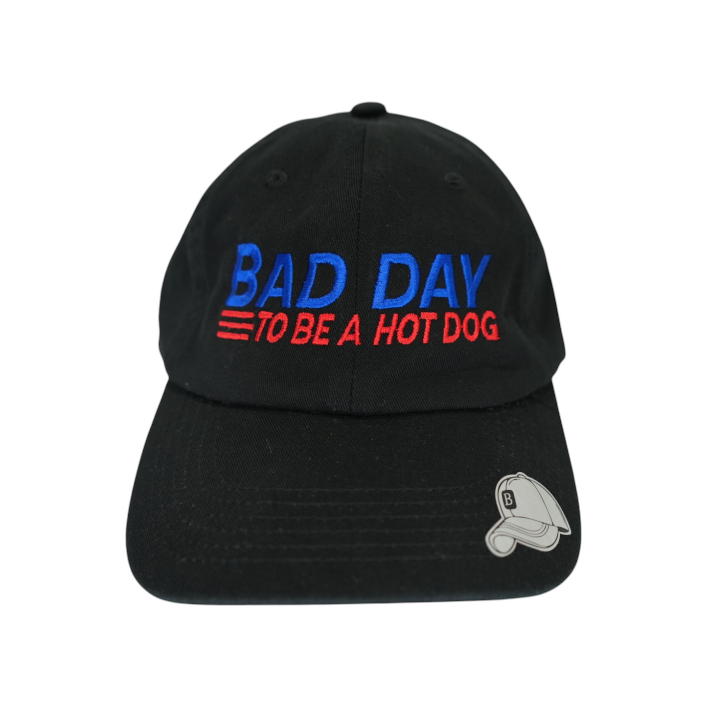 Front facing view of a black dad hat with “Bad Day to Be a Hot Dog” embroidered in blue and red.