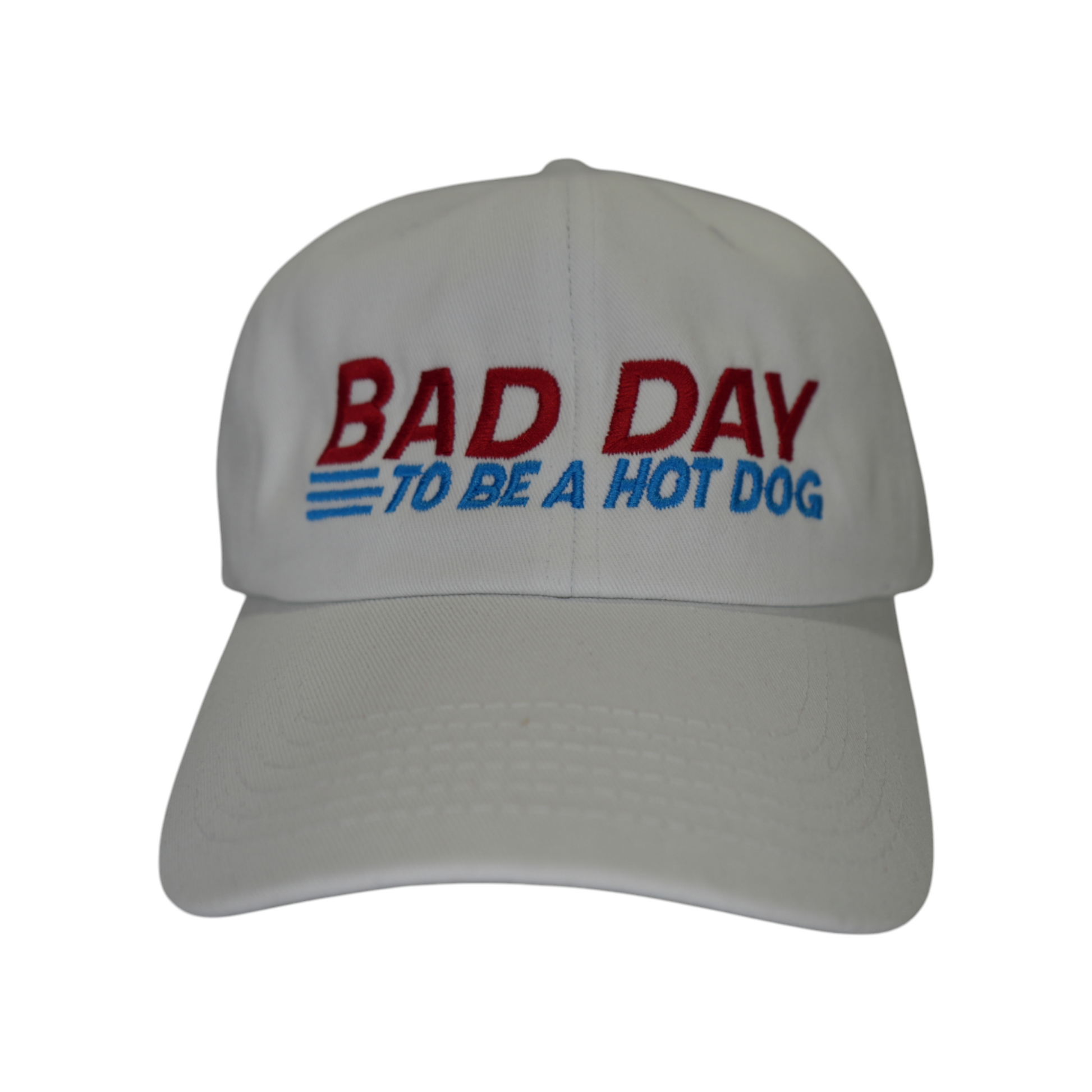 Front facing view of a white dad hat with “Bad Day to Be a Hot Dog” embroidered in red and baby blue.