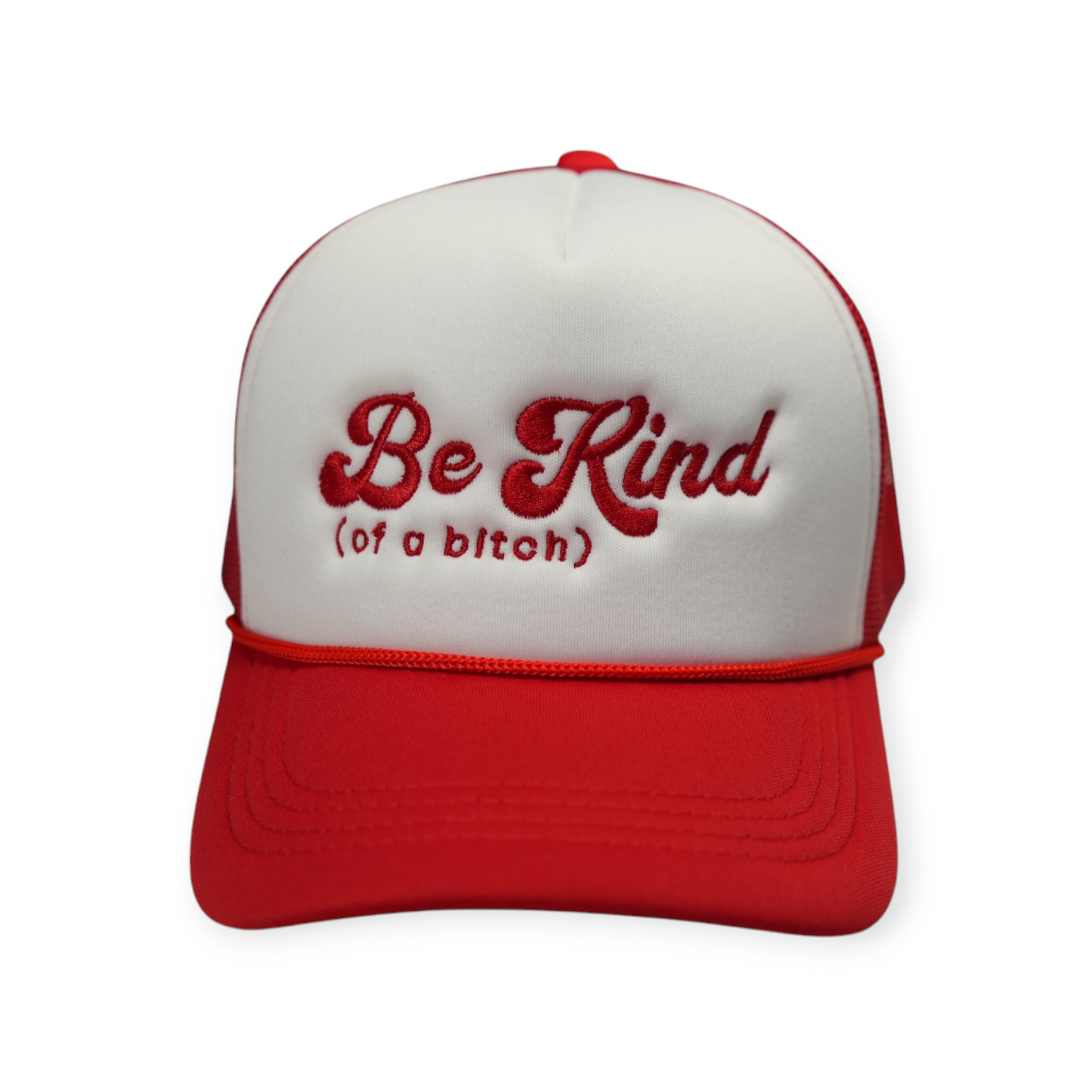A red and white trucker hat with red embroidery that says “Be Kind of a Bitch.”