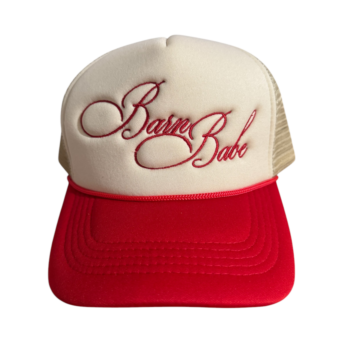 Front-facing red and beige trucker hat with a curved brim and mesh back, featuring “Barn Babe” embroidered in red across the front.
