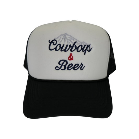 Front view of a black and white trucker hat with a white front panel and black bill, featuring “Cowboys & Beer” embroidered across the front in light blue, navy blue, and red.