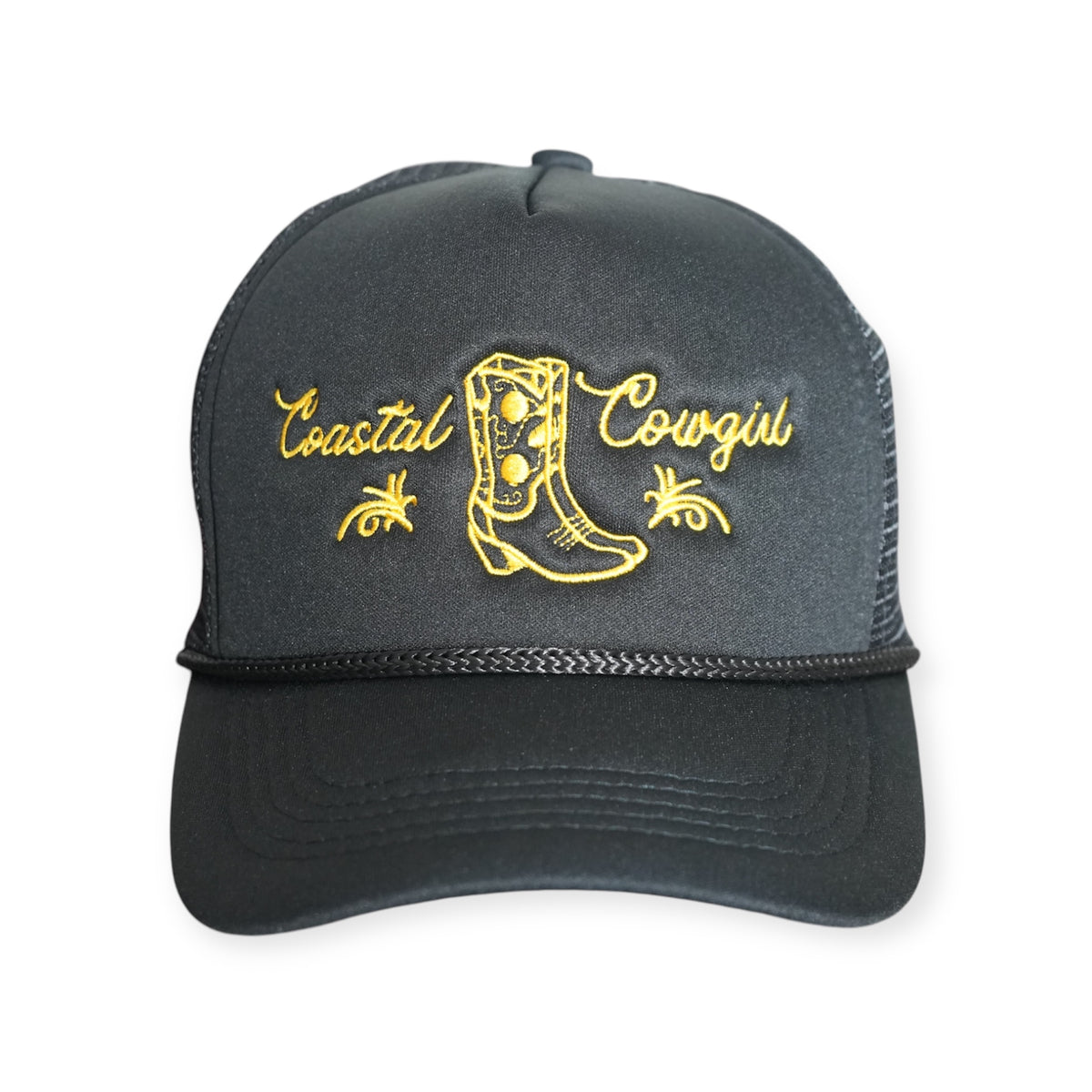 Front-facing Coastal Cowgirl V1 trucker snapback hat in black, featuring “Coastal Cowgirl” and a western boot embroidered in gold.