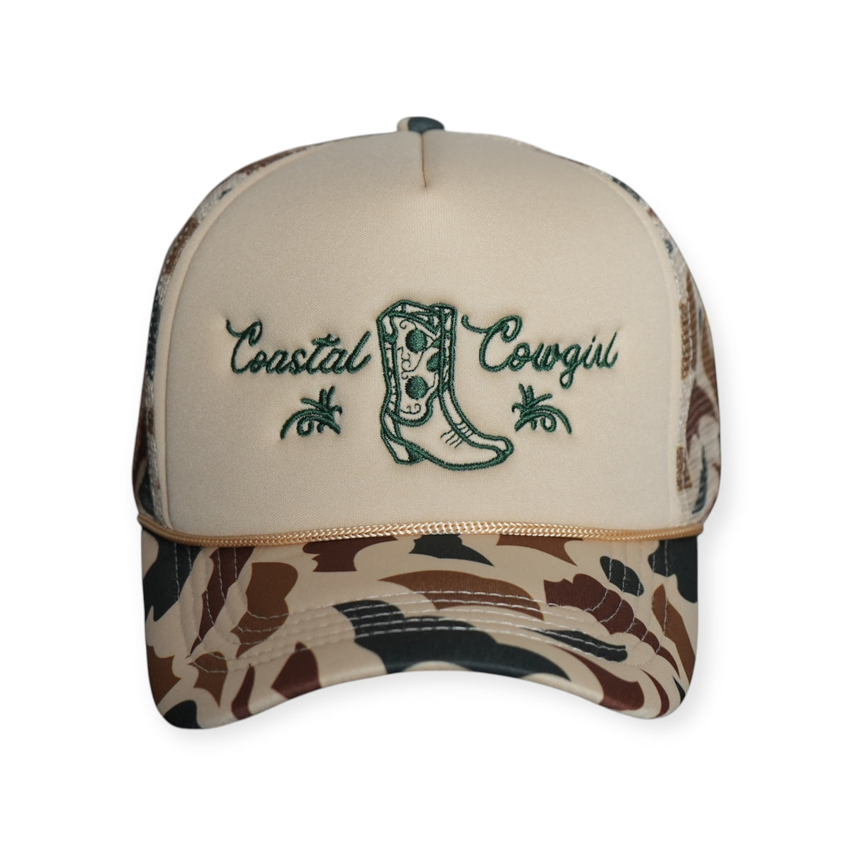 Front-facing Coastal Cowgirl V1 trucker snapback hat with a beige front and camo bill, featuring “Coastal Cowgirl” and a western boot embroidered in forest green.