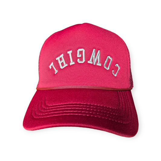 Front facing Cowgirl Upside Down trucker hat in burgundy with the word “Cowgirl” embroidered upside down in white on the front.